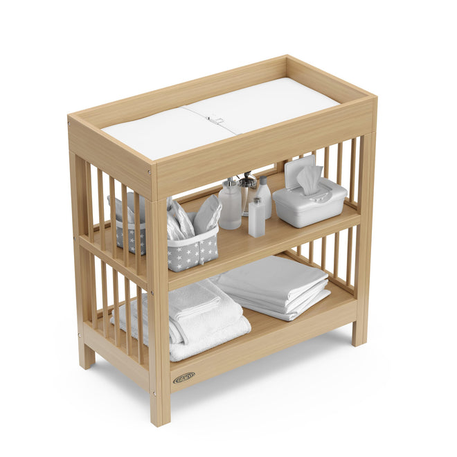 Graco Teddi Changing Table with Water-Resistant Changing Pad (Driftwood) - GREENGUARD Gold Certified, 2 Open Shelves, Includes Bonus Water-Resistant Changing Pad with Safety Strap 🍁 All In One Marketplace Canada
